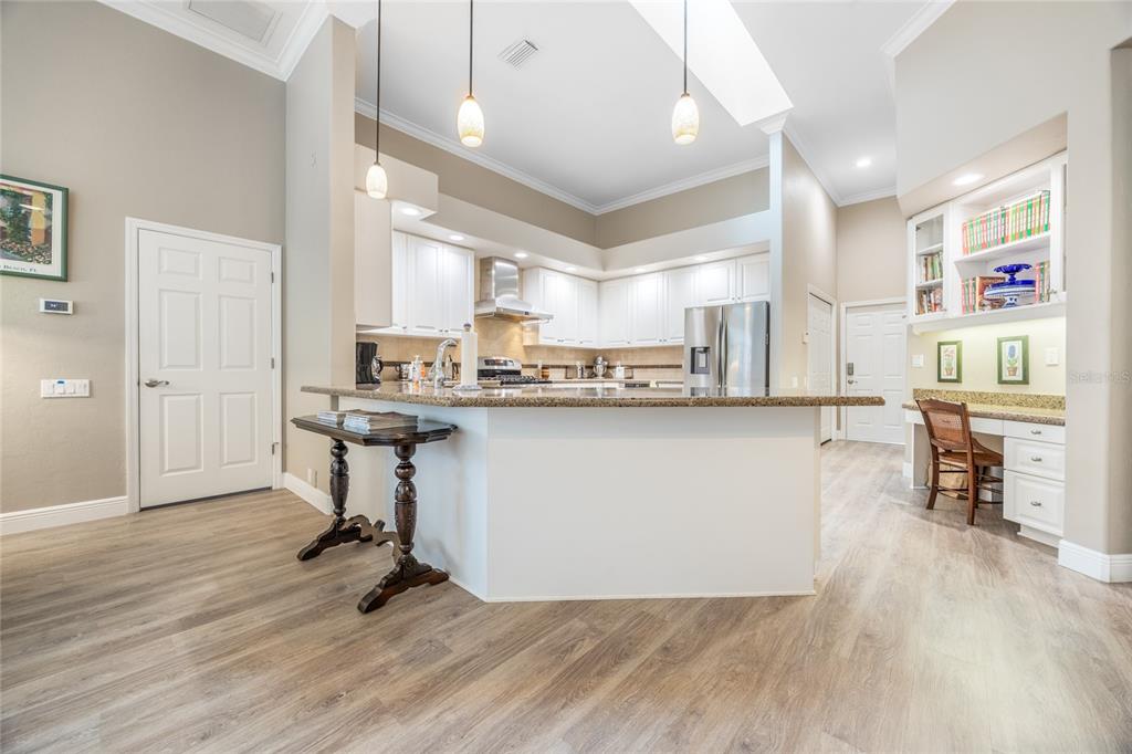 5922 Northwest 72 Street Gainesville, FL 32653 - Photo 12 of 52 a living room with stainless steel appliances kitchen island granite countertop a dining table chairs and a refrigerator