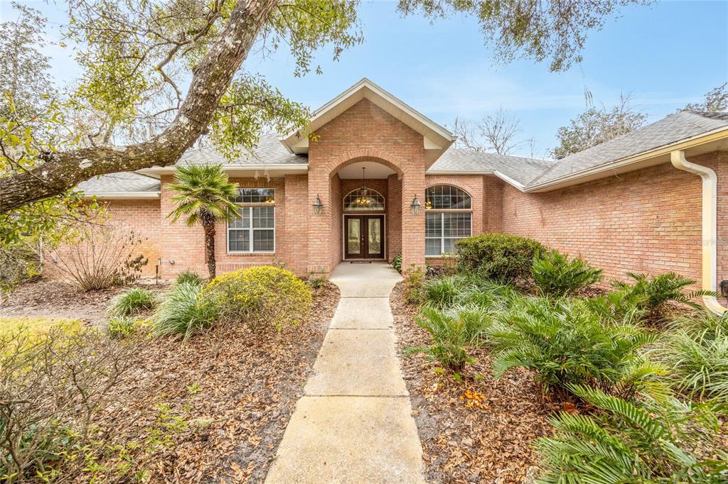 5922 Northwest 72 Street Gainesville, FL 32653 - Photo 2 of 52 a front view of a house with garden