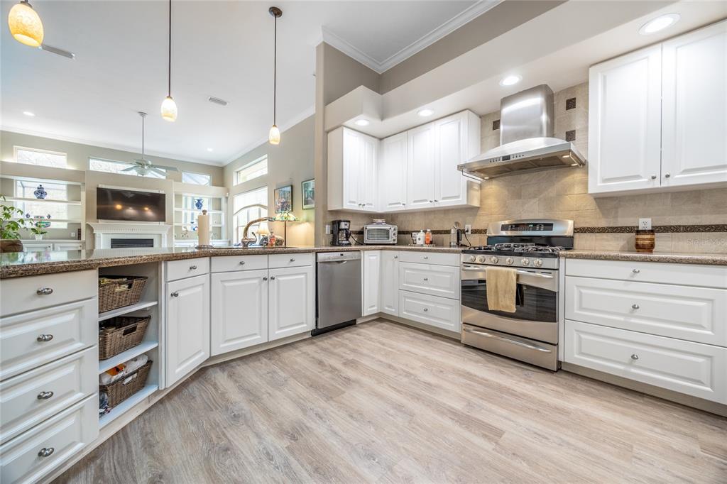 5922 Northwest 72 Street Gainesville, FL 32653 - Photo 22 of 52 a kitchen with white cabinets stainless steel appliances and sink