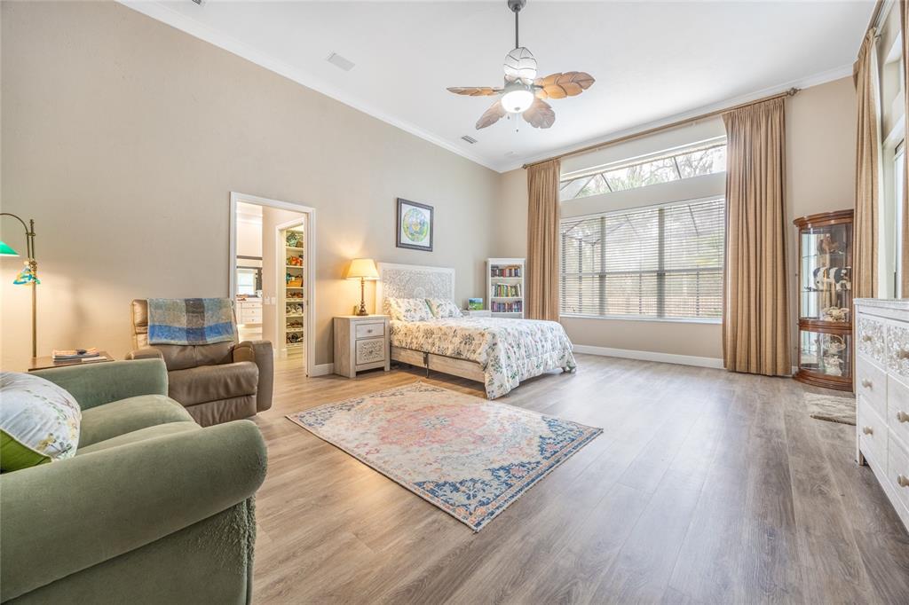 5922 Northwest 72 Street Gainesville, FL 32653 - Photo 26 of 52 a bedroom with furniture and a chandelier