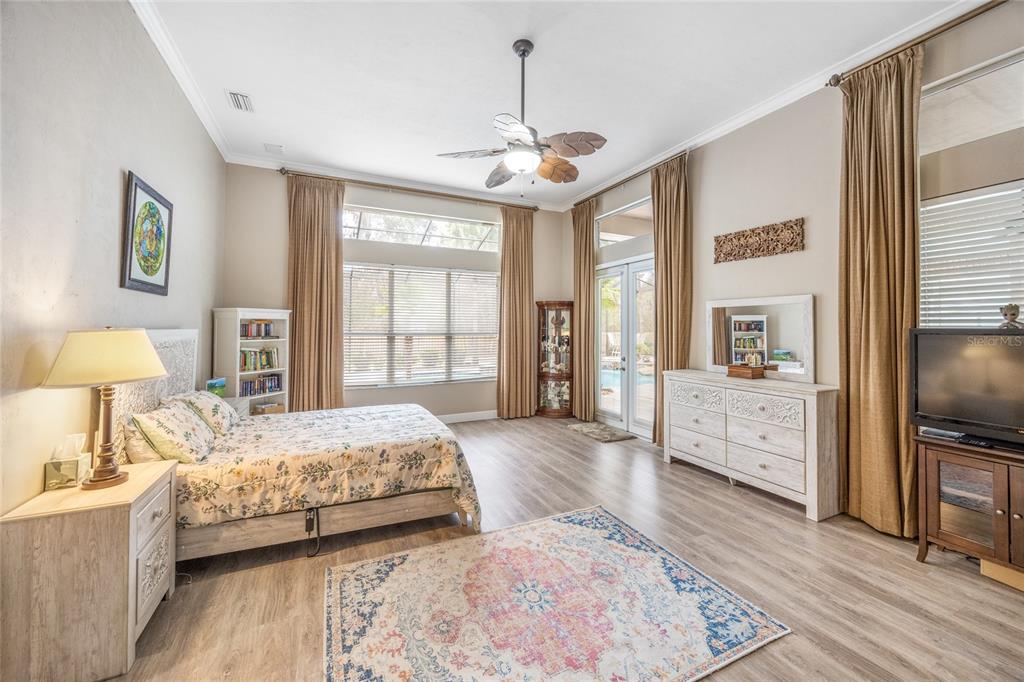 5922 Northwest 72 Street Gainesville, FL 32653 - Photo 29 of 52 a bedroom with a large bed a flat tv screen and dresser