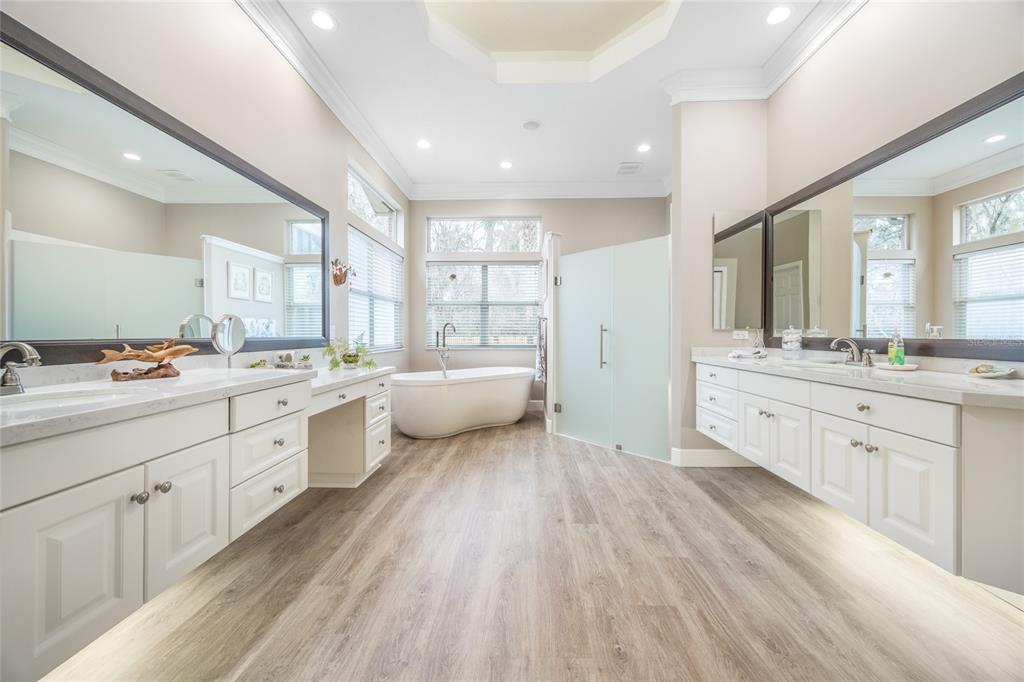 5922 Northwest 72 Street Gainesville, FL 32653 - Photo 30 of 52 a large bathroom with a double vanity sink a mirror and a bathtub