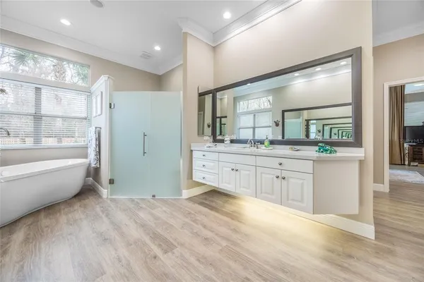 a view of a hallway with wooden floor and closet area
