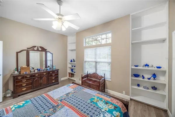 a bedroom with a bed mirror and a window