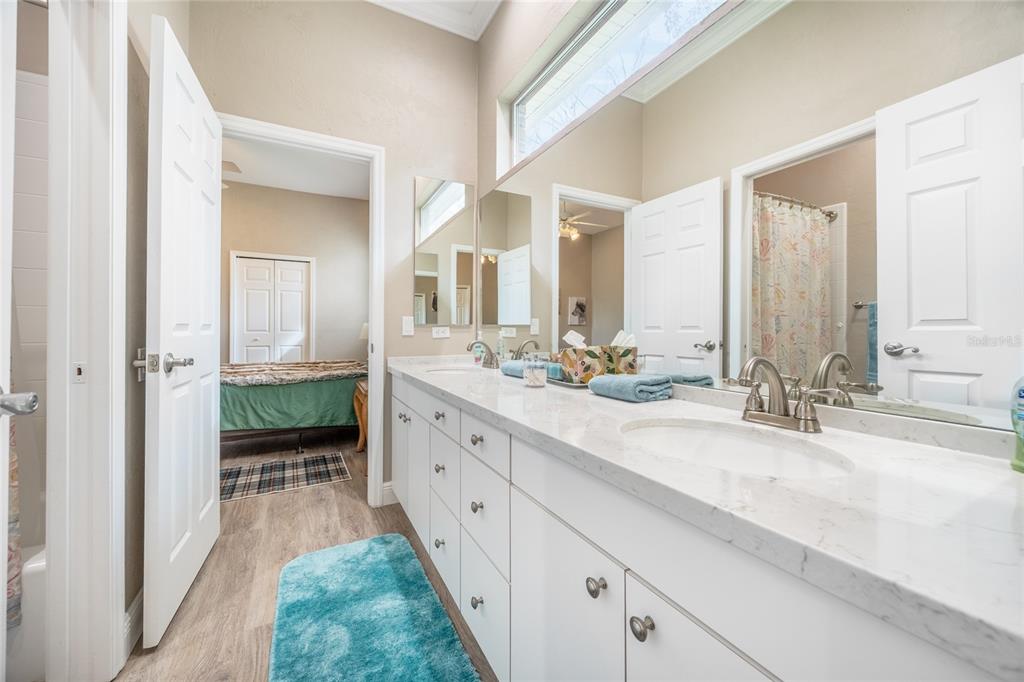 5922 Northwest 72 Street Gainesville, FL 32653 - Photo 40 of 52 a spacious bathroom with a double vanity sink mirror and a bathtub