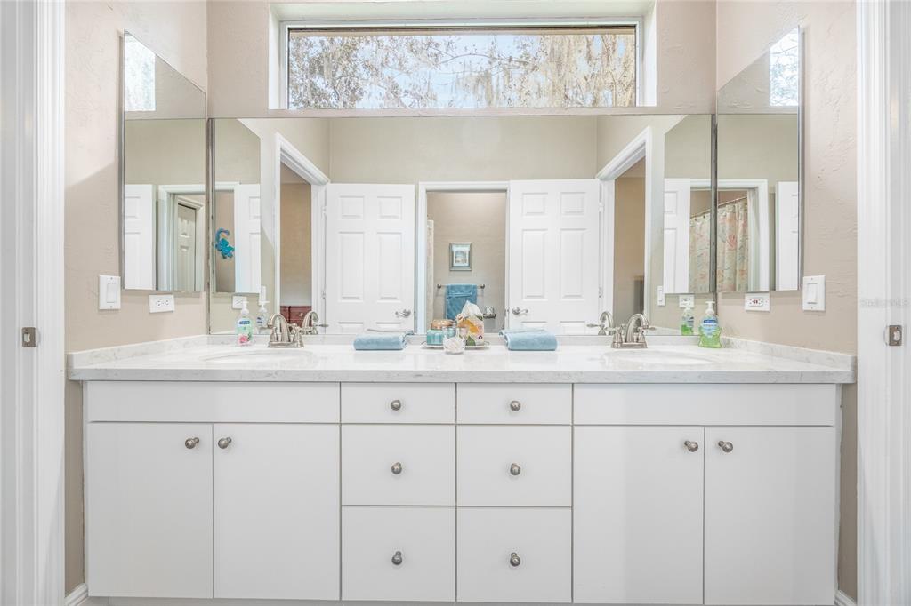 5922 Northwest 72 Street Gainesville, FL 32653 - Photo 41 of 52 a bathroom with double sink and a mirror