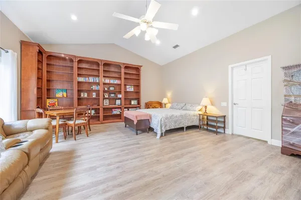 a bedroom with furniture and a large window