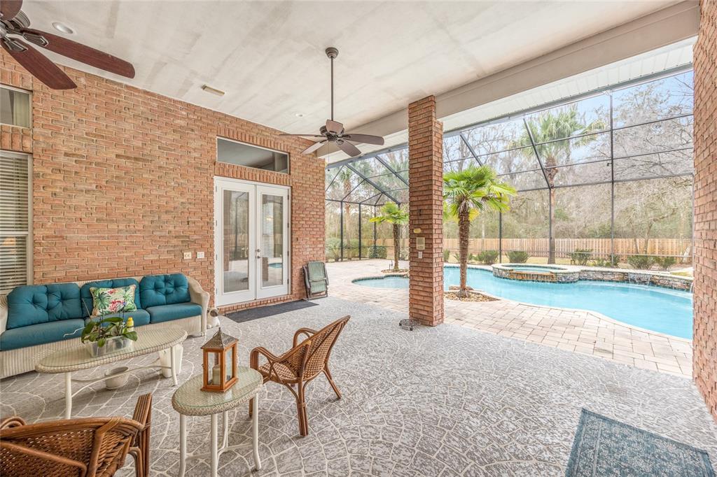 5922 Northwest 72 Street Gainesville, FL 32653 - Photo 48 of 52 a dining room with furniture a chandelier and a rug
