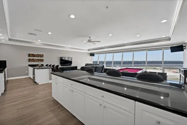 a kitchen with stainless steel appliances granite countertop a sink and white cabinets