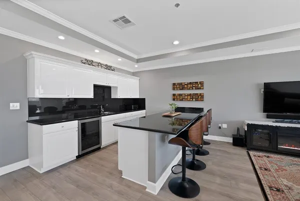 a kitchen with kitchen island a stove a sink and a refrigerator with wooden floor