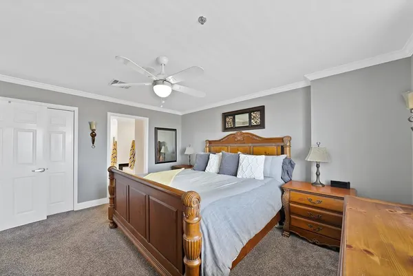 a bedroom with a bed and a chandelier