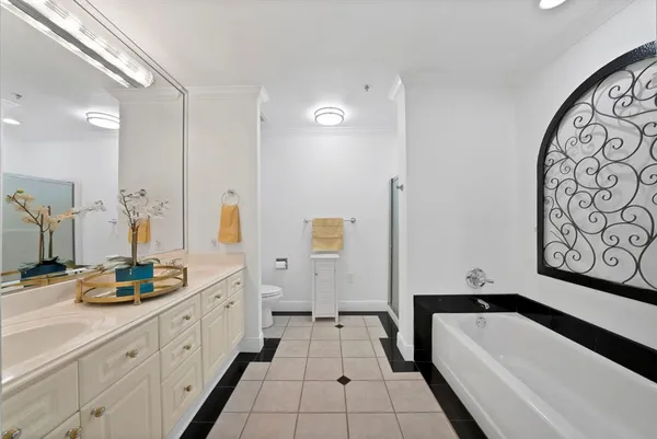a bathroom with a tub sink and mirror