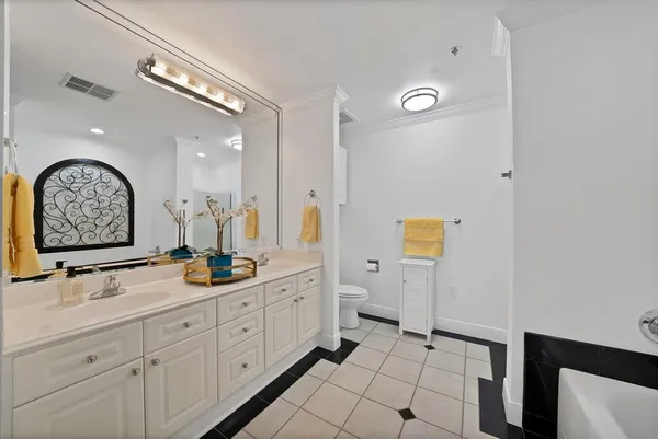 a spacious bathroom with a double vanity sink and a mirror