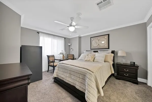a bedroom with a bed and a refrigerator