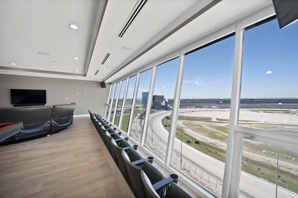 a view of a living room with a large window and wooden floor