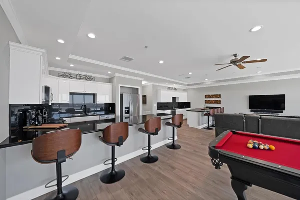 a living room with furniture pool and a flat screen tv