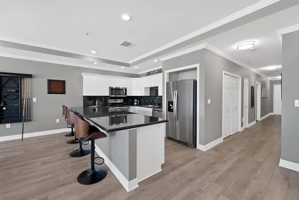 a kitchen that has a table and chairs in it