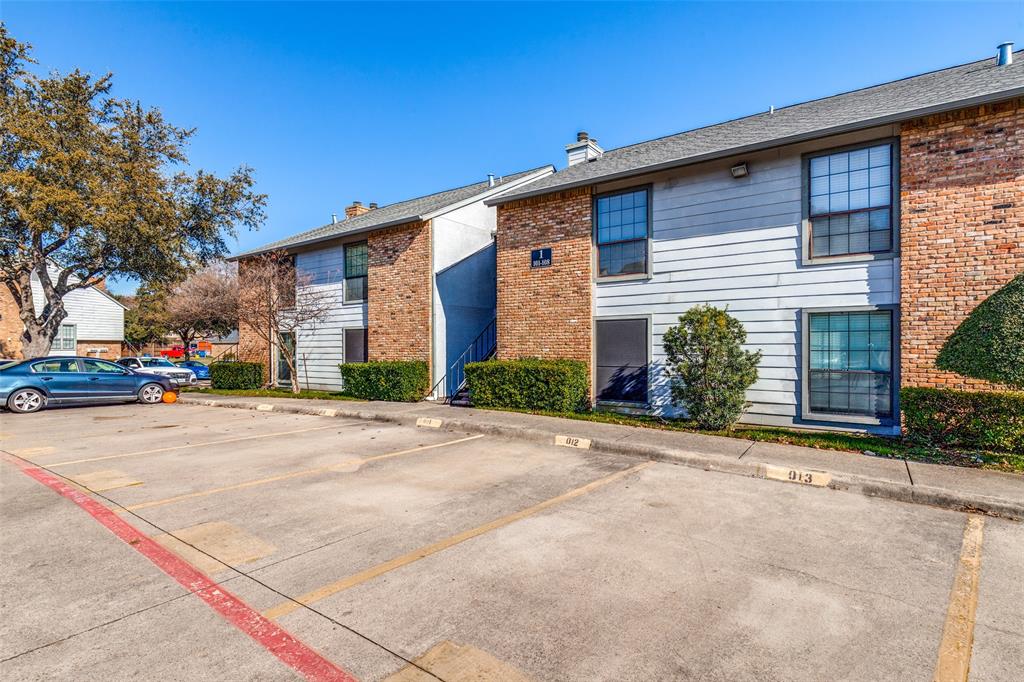 15151 Berry Trail, Unit 106 Dallas, TX 75248 - Photo 24 of 24 a front view of a house with a yard and garage