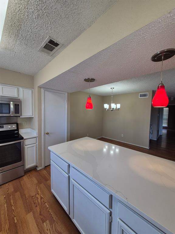 15151 Berry Trail, Unit 106 Dallas, TX 75248 - Photo 9 of 24 a kitchen with granite countertop a sink and cabinets