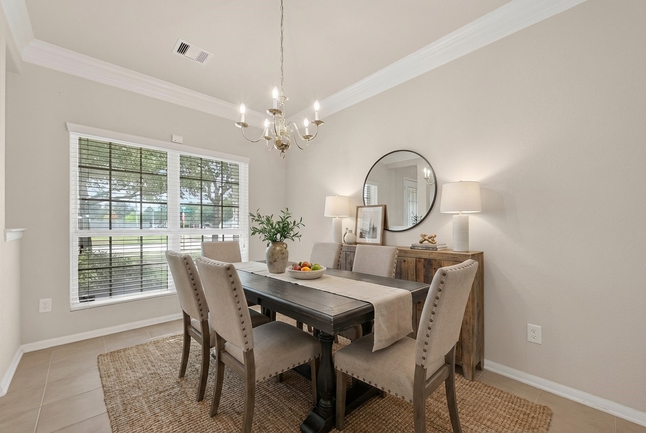 a view of a dining room with furniture a chandelier and wooden floor