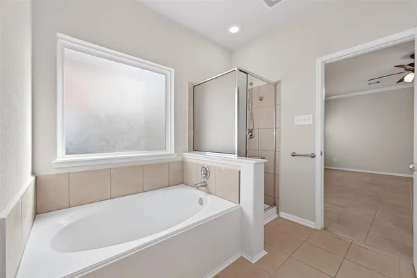 a spacious bathroom with a double vanity sink and a mirror