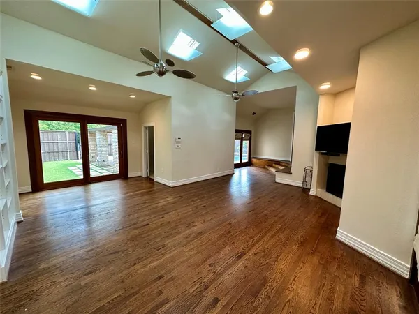 a view of a room with wooden floor closet and windows
