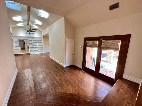 a view of room with window and hardwood floor