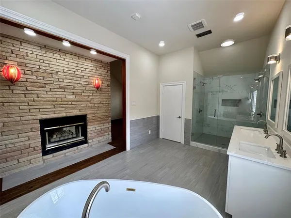 a hall with a fireplace and a wooden floor