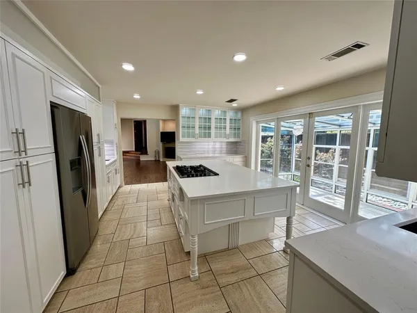 a kitchen with a stove sink and refrigerator
