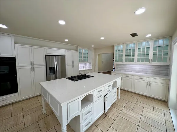 a kitchen with a sink window and cabinets