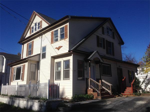 23 Emery Street Lowell, MA 01851 - Photo 5 of 5 a front view of a house with a yard