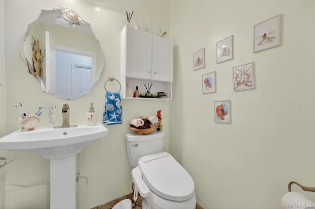 a bathroom with a sink a toilet and a mirror