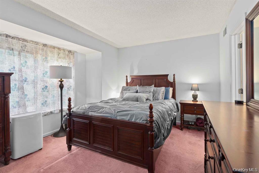 118 Elmcrest Drive Fishkill, NY 12524 - Photo 17 of 25 a bedroom with a bed and a lamp with window