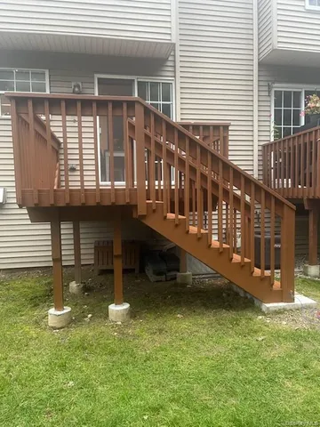 a view of a house with a yard and sitting area