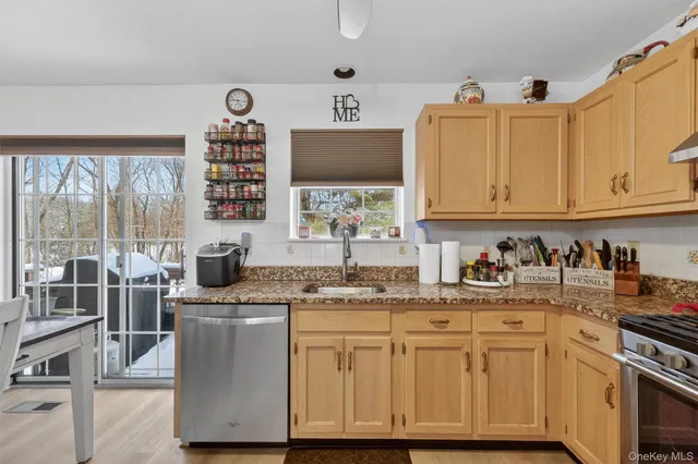 a kitchen with stainless steel appliances granite countertop a sink stove and cabinets