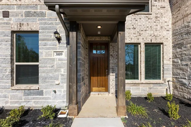 a front view of a house with a glass windows