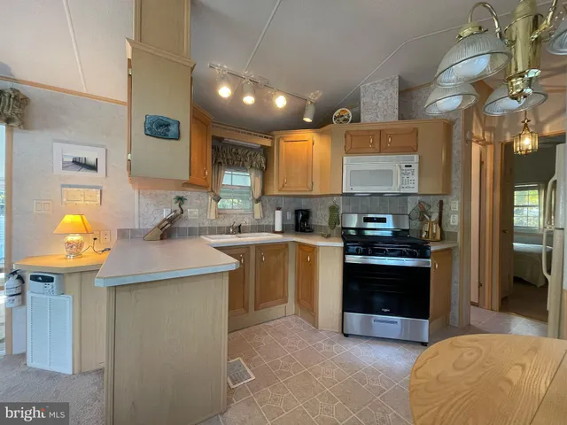 a kitchen with stainless steel appliances granite countertop a sink and a stove