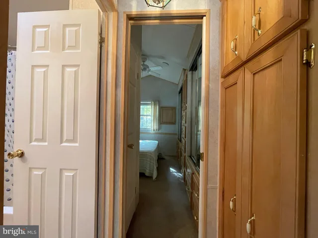 a view of a hallway with a dining table