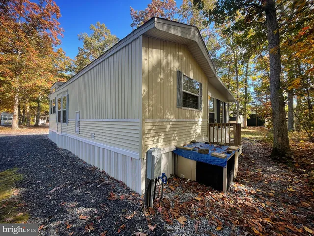 a front view of a house with garden and sitting area