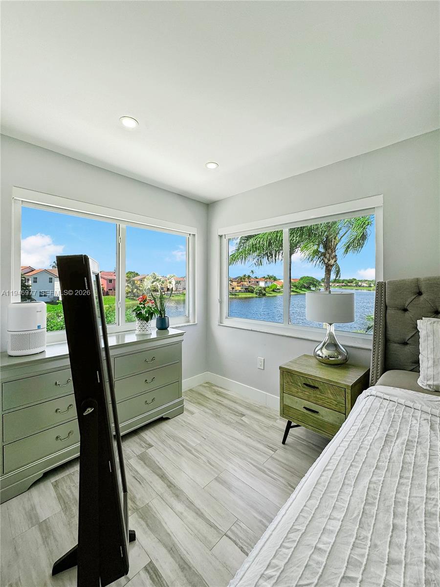 15481 Southwest 47th Terrace, Unit 15481 Miami, FL 33185 - Photo 2 of 29 a view of a workspace room with wooden floor and furniture