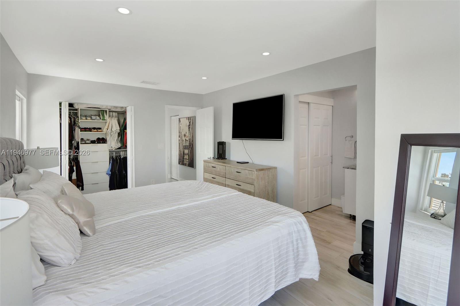 15481 Southwest 47th Terrace, Unit 15481 Miami, FL 33185 - Photo 23 of 29 a bedroom with a bed and a flat screen tv