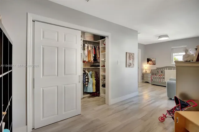 a view of walk in closet with clothes and shoes