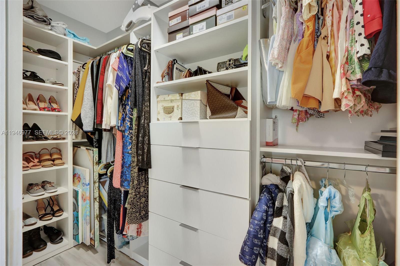 15481 Southwest 47th Terrace, Unit 15481 Miami, FL 33185 - Photo 27 of 29 a view of walk in closet with clothes and shoes