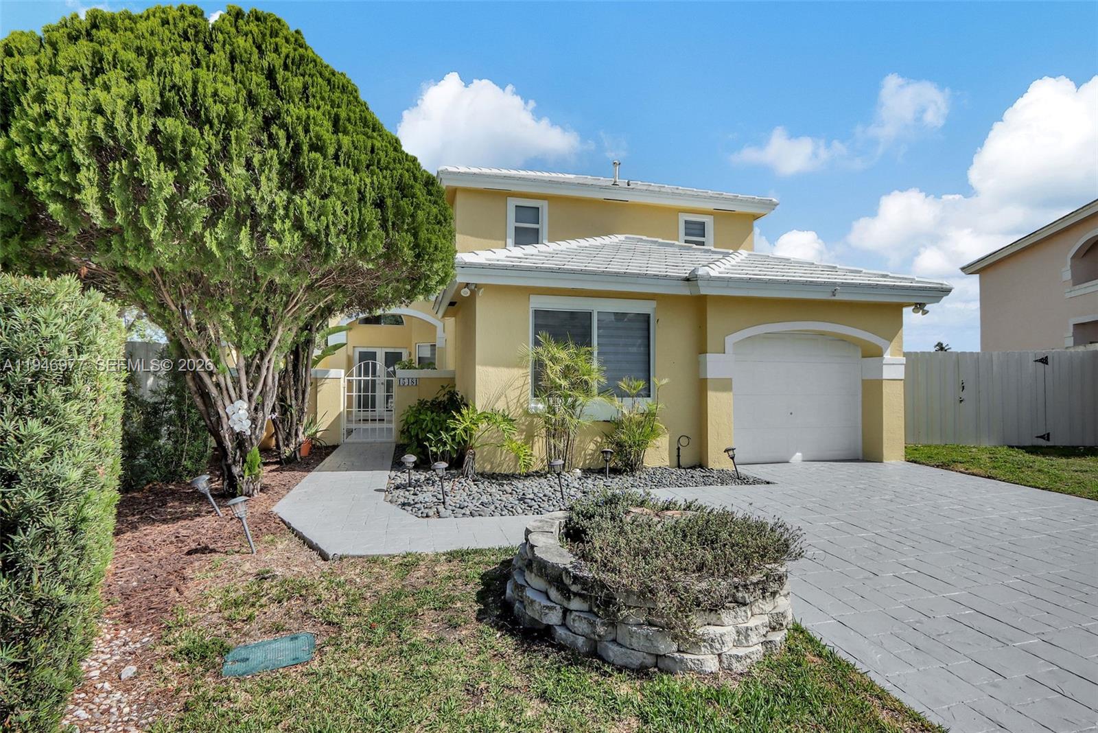 15481 Southwest 47th Terrace, Unit 15481 Miami, FL 33185 - Photo 6 of 29 a front view of a house with a yard