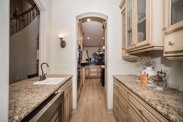 a kitchen with a sink a stove and chairs