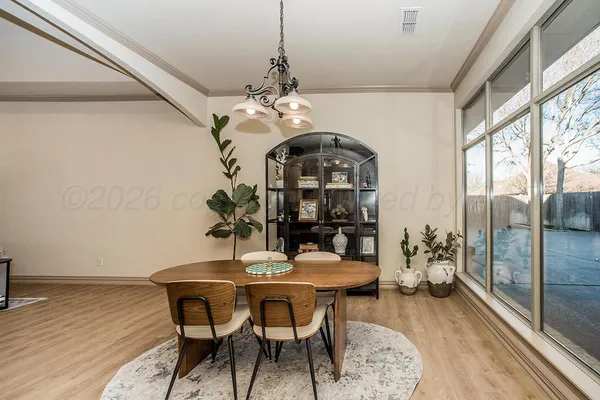 a living room with furniture a fireplace and a floor to ceiling window
