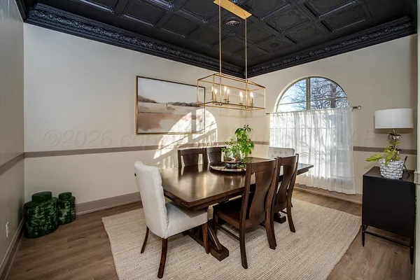 a dining room with furniture and wooden floor