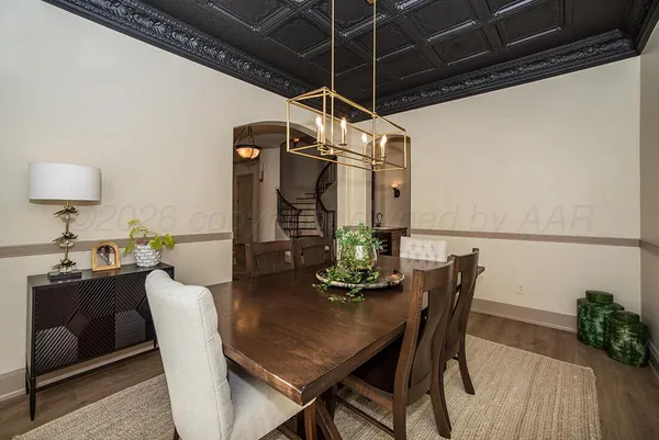 a view of entryway with wooden floor and dining room