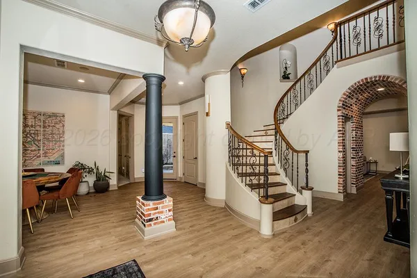 a dining room with furniture potted plants and wooden floor