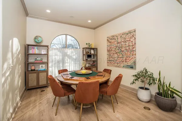 a living room with furniture a rug and wooden floor